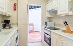 a kitchen with a sink and a microwave at Lovely Apartment In Mijas With Wifi in Mijas