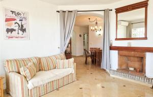 a living room with a couch and a fireplace at Lovely Apartment In Mijas With Wifi in Mijas