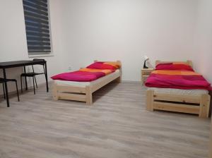 Postel nebo postele na pokoji v ubytování Apartmány Kortan