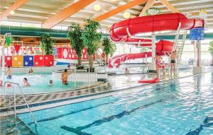 a large swimming pool with people in the water at 3 Bedroom Lovely Home In Vlagtwedde in Vlagtwedde
