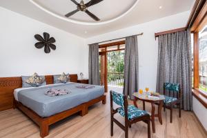 a bedroom with a bed and a table and chairs at Villa Calangute Phase 11 in Calangute