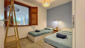 Postel nebo postele na pokoji v ubytování Villa Sao Scopello Punta Pispisa