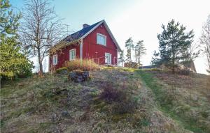 a red house sitting on top of a hill at Beautiful Home In Vilshult With Kitchen in Vilshult +15 photos