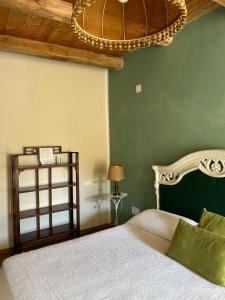 a bedroom with a bed and a chandelier at B&B Casa CamiLory in San Lucido