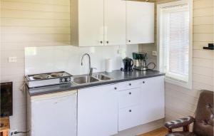 a kitchen with white cabinets and a sink at Beautiful Home In Kleppe With Wifi in Bore