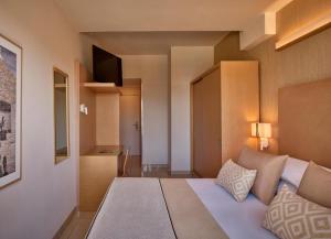 Postel nebo postele na pokoji v ubytování GranSerena Hotel