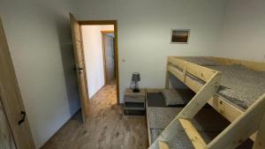 a small room with a bunk bed and a hallway at Dwupoziomowe Apartamenty Leszczyna in Ustroń +41 photos