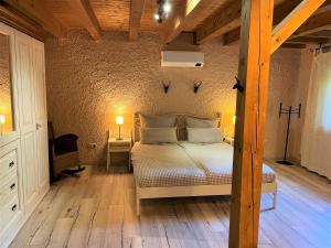 a bedroom with a bed and a wooden floor at Montara Suites Bodenmais I aktivCARD Bayerischer Wald inklusive in Bodenmais