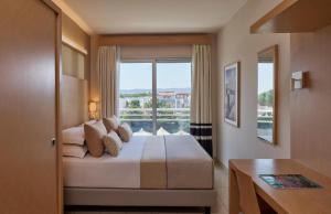 Postel nebo postele na pokoji v ubytování GranSerena Hotel