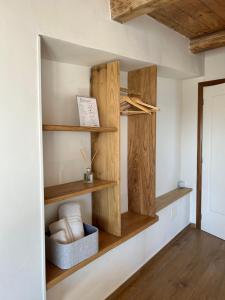 a room with wooden shelves on the wall at B&B Casa CamiLory in San Lucido
