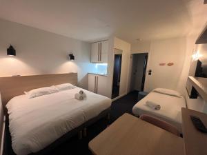Postel nebo postele na pokoji v ubytování Appart'Hôtel Lauréades Clermont-Ferrand Centre Jaude