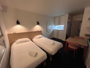 Postel nebo postele na pokoji v ubytování Appart'Hôtel Lauréades Clermont-Ferrand Centre Jaude