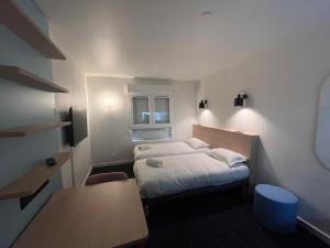Postel nebo postele na pokoji v ubytování Appart'Hôtel Lauréades Clermont-Ferrand Centre Jaude