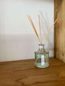 a glass vase with sticks in it on a table at B&B Casa CamiLory in San Lucido