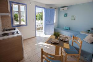 a kitchen and a living room with a table in a room at Astarti Apartments in Livadi