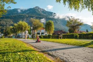 a family walking down a path in a park at EuroParcs Hermagor - Nassfeld in Hermagor +24 photos