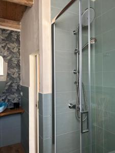 a shower with a glass door in a bathroom at B&B Casa CamiLory in San Lucido