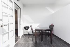 a table and chairs in a room with a door at Apartamentos Gama in Cala Galdana
