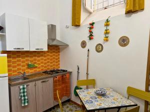 a kitchen with a table and a sink and a stove at Orange Lemon Center Palermo in Palermo +50 photos
