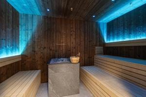 a sauna with a blue lighting and a tub at Montafon Suites Schruns by ALPS RESORTS in Schruns