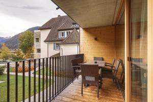 a patio with a table and chairs on a balcony at Montafon Suites Schruns by ALPS RESORTS in Schruns +93 photos