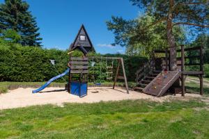 a playground with a slide and a climbing frame at Domek letniskowy Patricia in Sulęczyno