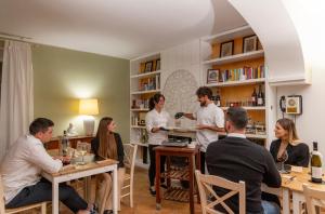 a group of people sitting at tables in a restaurant at Villa LeMarche b&b in Rustico +44 photos