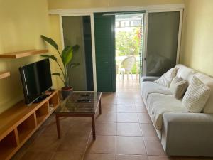 a living room with a couch and a coffee table at Caserío Garden in San Bartolomé de Tirajana
