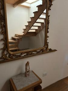 a mirror on a wall with a stairway at B&B Casa CamiLory in San Lucido
