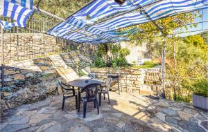 レッコにあるBeautiful Apartment In Recco With Wifiのパティオ(テーブル、椅子、パラソル付)