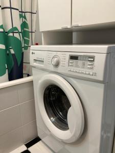 a washing machine in a bathroom with at STUDIO APP STELLA Jarun Zagreb SELF-CHECK-IN in Zagreb