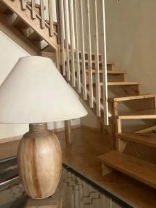 a wooden lamp sitting on the floor next to a staircase at B&B Casa CamiLory in San Lucido