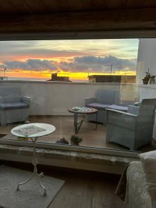 a view of a living room with a table and chairs at B&B Casa CamiLory in San Lucido