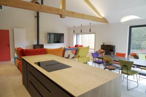 a kitchen and living room with a table and chairs at Abacus in Assesse