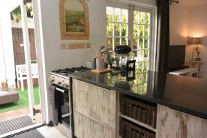 a kitchen with a stove and a counter top at Nirvana Cottage in Cape Town