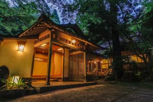 a house with lights on the front of it at Tsukihitei in Nara