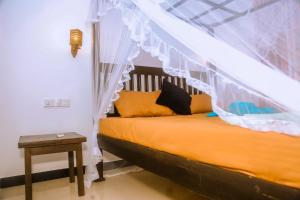 a bedroom with a bed with a canopy at Brave resort Mirissa in Mirissa