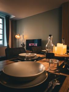 Una mesa con platos y una botella encima. en La Cité Voltaire, en Carcassonne