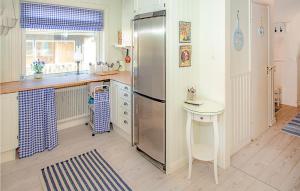 a kitchen with a stainless steel refrigerator and a table at Stunning Home In Höganäs With Wifi in Höganäs