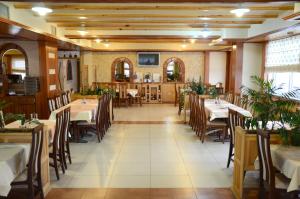 a restaurant with tables and chairs in a room at Hotel Kupres in Kupres