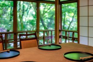 a table with two green plates on top of it at Tsukihitei in Nara