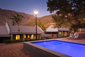 a swimming pool in front of a house at Mont Angelis in Stellenbosch