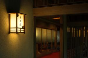 a light on the side of a building with a door at Tsukihitei in Nara
