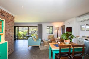 a kitchen and living room with a table and chairs at Mont Angelis in Stellenbosch