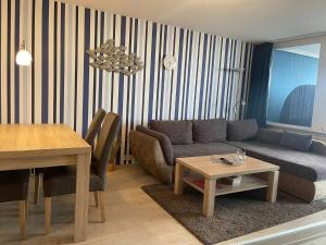 a living room with a couch and a table at Ferienwohnung Wolke 7 in Bremerhaven