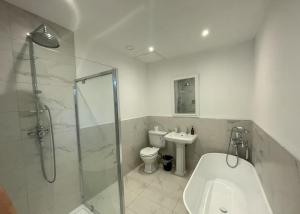a bathroom with a shower and a toilet and a sink at Beaumont Mews in Saint Albans +56 photos