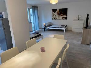 a white table and chairs in a living room at For Workers Kleve in Kleve