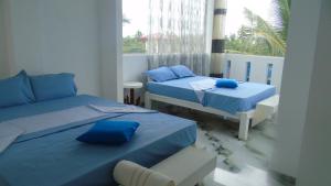 Postel nebo postele na pokoji v ubytování Ro Rich Hotel + 37 fotografií