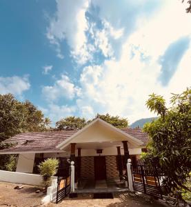 a house with a fence in front of it at Green and Green in Vagamon +53 photos