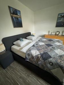 a bedroom with a bed with a quilt on it at Ferienwohnung Sylt in Meinerzhagen
